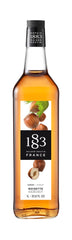 1883 Hazelnut front glass bottle showing elegant label and café-ready presentation