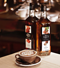 1883 Maison Routin syrup pouring action into cup showing smooth texture and easy mixing benefit