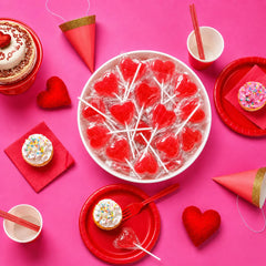 A Great Surprise bowl filled with individually wrapped heart lollipops for serving