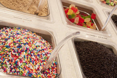 A Great Surprise spoonful of sprinkles over ice cream adding colorful contrast