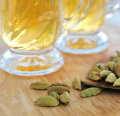 Steaming cup of Ahmad Tea cardamom green tea in kitchen scene for daily enjoyment