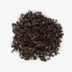 Ahmad Tea loose leaf closeup of rolled gunpowder pearls, highlights rich texture