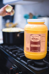 Amish Country Popcorn pouring oil into pan for popping, ensures even heating