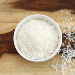 Anthony's shredded coconut in measuring cup for portioning, shows 2 lb scale