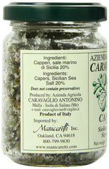 Antonino Caravaglio capers on crostini in kitchen setting, adds bright savory finishing touch