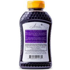 Arvoli elderberry honey bottle next to measuring spoon showing serving size and scale