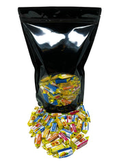 Assortit individually wrapped candies scattered to show hygienic single-serve benefit