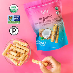 Hand holding Ava Organics coconut roller to show scale and portable snack size for on-the-go