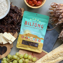 Ayoba opened pack revealing thin biltong slices, convenient high-protein portion