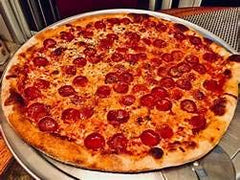 Battistoni slices on pizza close-up showing cupped pepperoni and intensified flavor