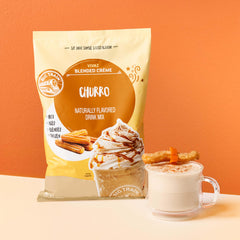 Big Train churro frappe in a glass topped with whipped cream and cinnamon