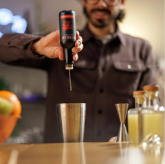 Bittercube pouring dashes into a stirred cocktail demonstrating flavor control