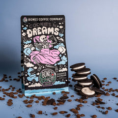 Hand holding Bones Coffee beans to show scale, emphasizes quality whole‑bean control