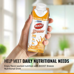 BOOST Breeze being poured into a glass, refreshing orange drink
