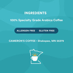 Measuring spoon with Cameron's Coffee grounds showing portion control for consistent brews