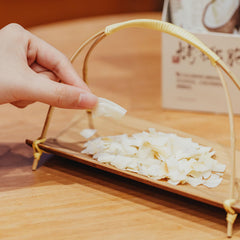 MODERN CHINA TEA SHOP coconut flakes served in bowl as snack to add tropical crunch