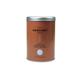 Coffee Bean & Tea Leaf tin front showing brand and hazelnut creamer convenience
