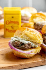 Colman's mustard being blended into a dry rub on meat for enhanced grilling flavor