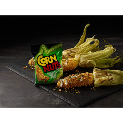 Hand holding a 4 oz Corn Nuts bag to show convenient portable portion size