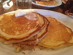 Cracker Barrel stacked pancakes served with syrup showing restaurant-style appeal