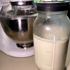 Pouring Cultures For Health buttermilk into batter to boost baking tenderness and rise