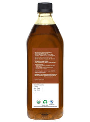 Close-up of oil surface with seed residue, showing unrefined cold-pressed authenticity