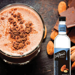 Close-up of almond syrup pouring from bottle highlighting texture and smooth pourability