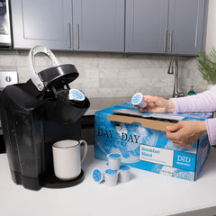 Day To Day Coffee pod inserted in brewer for quick, consistent cup