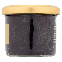 Elsinore 100g tin beside a spoon to show compact size and serving control