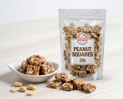 EMPORIUM single peanut square held to show size and satisfying crunch
