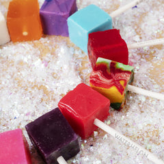 Espeez cube pop next to a ruler and stick showing size and individual wrapping convenience