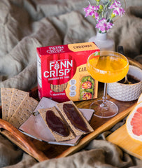 Finn Crisp stack beside a hand for scale illustrating thin, packable size