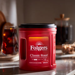 Folgers open canister with spoon showing scoopable grounds for convenient measuring