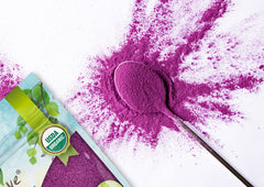 Food to Live powder scooped into spoon for easy measuring and use
