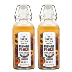 Fresh Press Farms front packaging showing two glass bottles and fruity peach label benefit: clear organic branding
