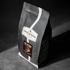 Fresh Roasted Coffee whole beans spread on table showing even roast and aroma