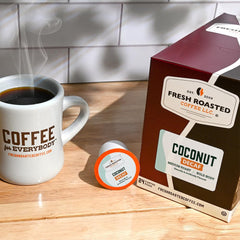 Fresh Roasted Coffee pod in hand demonstrating pod size and easy single-serve brewing convenience