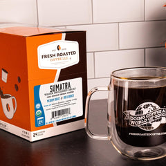 Fresh Roasted Coffee pod with opened foil lid displaying ground coffee for aroma