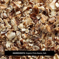 Wooden scoop of Frontier Co‑op pinto bean flakes over bowl, easy portioning benefit