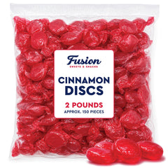Fusion Sweets scattered cinnamon discs on white surface showing bold color and quantity