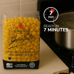 Hand holding Garofalo Lumachine dry pasta, shows single-ingredient durum wheat semolina