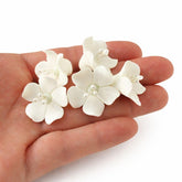 Global Sugar Art front box display showing 24 white gum paste flowers for quick decorating