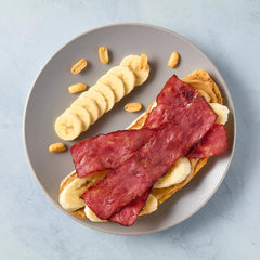 Godshall's cooked turkey bacon sizzling in a skillet showing quick reheating and crisp result