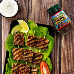 Grilled chicken coated in Grace seasoning demonstrating smoky, charred results
