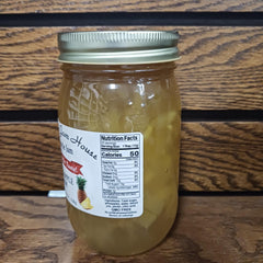 Grandma's Jam House jar beside toast in kitchen scene offering bright pineapple flavor