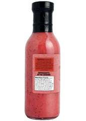 Green Jay Gourmet dressing poured on spinach salad adding fruity flavor