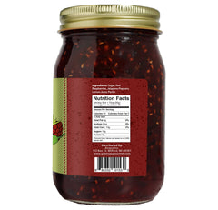 Green Jay Gourmet jam spooned from open jar, highlights spreadability benefit