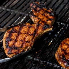 Grill Mates applied on pork chops for caramelized sweet-smoky crust