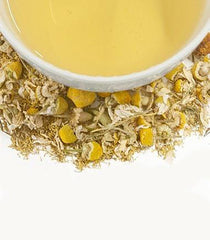 Harney & Sons brewed cup with sachet in a cozy setting demonstrating soothing, caffeine-free relaxation