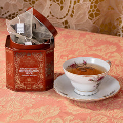 Harney & Sons brewed tea in cup on table with tin nearby illustrating cozy serving